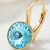 Pozłacane kolczyki z okrągłym kryształem Swarovski® w kolorze Light Turquoise