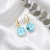Kolczyki damskie wiszące z kryształami Swarovski® 10 mm w jasnoturkusowym kolorze