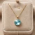 Elegancki pozłacany naszyjnik z kryształem Swarovski® 12 mm w kolorze Light Turquoise